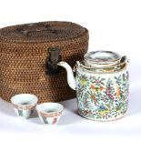 Canton porcelain teapot Chinese, circa 1900/1920 with two tea bowls in original wicker carrying