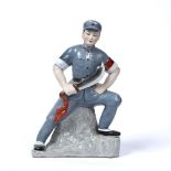 Porcelain Communist figure of a man Chinese, 20th century decorated in a soldier's uniform,