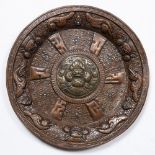 Copper and brass charger Tibetan embossed with Buddhist symbols and inset with turquoise 34.5cm