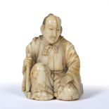 Well carved okimono of a priest Japanese, Mid Meiji dressed in long floral decorated robes while
