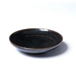 Jian ware small saucer shaped dish Chinese, Northern Song decorated with all over black glaze, the