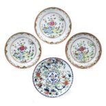Three famille rose large saucer dishes Chinese, circa 1800 painted with a garden scene of birds,