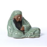 Daruma celadon figure Chinese depicted sitting cross legged holding his beard 18cm high