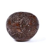 Carved coconut lamp Balinese carved with foliate scrolls and deities. 18cm across