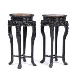 Two similar hardwood stands Chinese, late 19th Century each with inset rose marble tops and