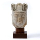 Marble carved Buddha's head Sino-Tibetan, possibly 17th/18th Century on a later wooden stand 23cm