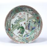 Famille verte saucer dish Chinese, Kangxi (1661-1722) decorated with three figures standing beside a