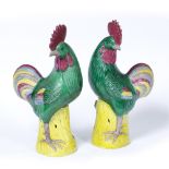 Pair of cockerels Chinese, 20th Century each bird facing forward on a yellow ground base 36cm high