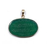 Green hard stone oval panel Qajar with Islamic inscription engraved into it, mounted in a metal