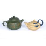 Two Yixing teapots Chinese, 20th Century the first of olive green colour decorated to the sides