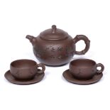 Yixing teapot and two cups and saucers Chinese, 20th Century the teapot with inscription and