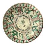 Eastern style dish Persian decorated to the inside with four panels of flowers with green and orange