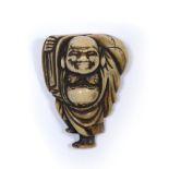 Ivory netsuke of Hotei Japanese, Edo Period carrying his sack over his right shoulder while standing
