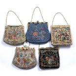 Five fabric purses Chinese all with floral decoration with gilt metal mounts to the clasp, some