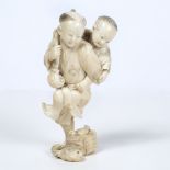 Ivory okimono carved as a boy Japanese, late Meiji carrying a younger sibling as he stands on one