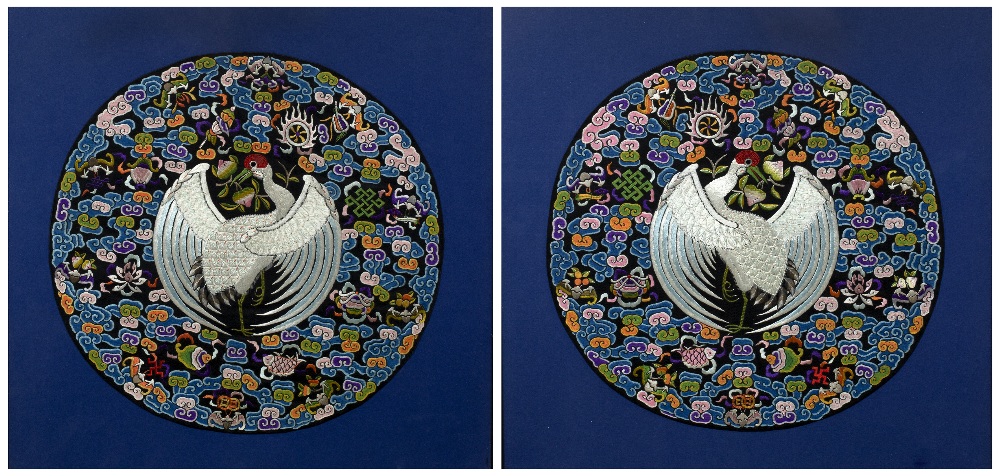 Pair of circular embroidered panels Chinese, 20th Century decorated with a central peacock in flight