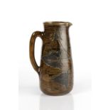 Robert Wallace Martin at Martin Brothers jug, decorated with holly leaves, inscribed 'R W Martin,