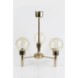 Contemporary three branch ceiling light with gold lacquered finish, spherical shade with amber hue