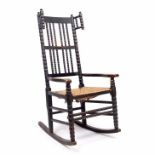 Manner of Ernest Gimson (1864-1912) rocking chair, circa 1900, ebonised, bobbin turned uprights,