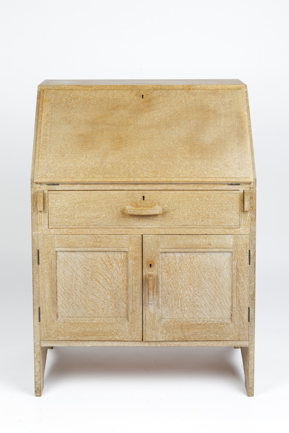 In the manner of Heals bureau, limed oak, long drawer above a cupboard, unmarked 74cm x 105cm x 42cm