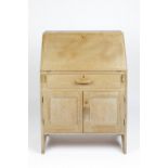 In the manner of Heals bureau, limed oak, long drawer above a cupboard, unmarked 74cm x 105cm x 42cm