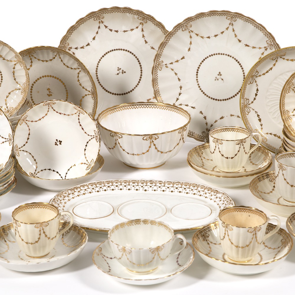 Derby porcelain part tea set 19th Century, with gilt husk and swag decoration, some pieces with puce