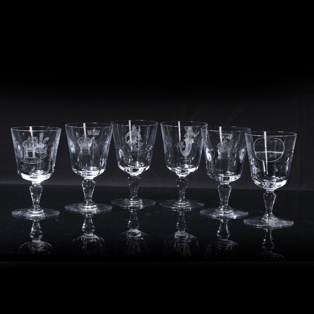 Group of five Baccarat of France wine glasses variously etched, including coat of arms, oval