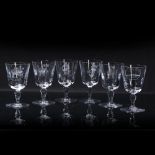 Group of five Baccarat of France wine glasses variously etched, including coat of arms, oval