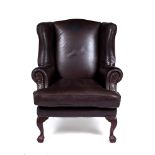 Leather wingback armchair contemporary, on ball and claw feet, 73cm across, 116cm high Provenance: