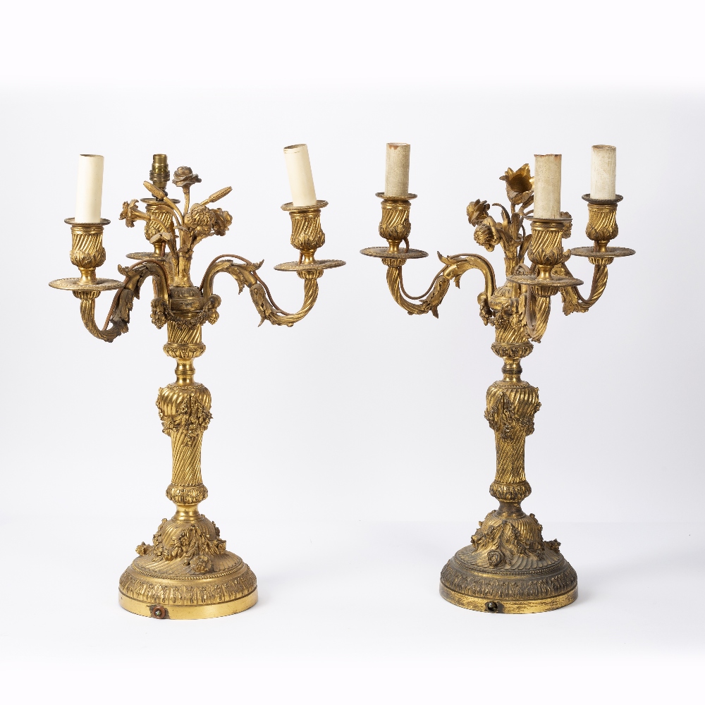 Two similar Regency ormolu candelabras 19th Century, the centre pillar surmounted with foliate
