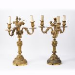 Two similar Regency ormolu candelabras 19th Century, the centre pillar surmounted with foliate