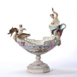 Continental porcelain bisque model of a basket in the form of a gondola with winged creature and