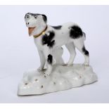 English porcelain model of a Newfoundland dog circa 1845, standing upright on a rocky bed, 9.5cm