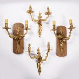 Two pairs of gilt metal wall sconces or wall lights one pair mounted onto oak plinths, both of