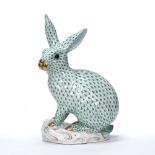 Herend model of a rabbit modelled seated with its ears pricked, decorated in green, painted