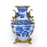 Large blue and white porcelain vase Chinese, with gilt metal mounts, scenes depicting figures in a