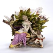 Large porcelain basket Volkstedt, in the form of a maiden and putti with flower and rockwork base,