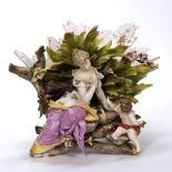 Large porcelain basket Volkstedt, in the form of a maiden and putti with flower and rockwork base,