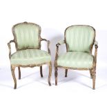 Two original carved and painted French fauteils 19th Century, each with later green striped