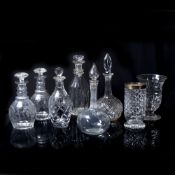 Six glass decanters and stoppers of varying styles, together with a cut glass flower vase with