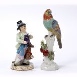 Continental porcelain model of a parrot modelled on a tree stump, together with a Meissen style