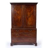 Mahogany linen press 19th Century, the upper part with panel doors fitted drawers below, 122cm