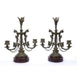 Pair of brass twin branch candlesticks with bird finials, ivy leaf decoration standing on marble
