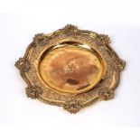 Gilt bronze plate 19th Century, with a foliate and shell shaped border, with a central lion monogram