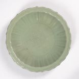 Celadon Longquan charger Chinese, Ming (1368-1644) the glazed dish of foliate form, with central