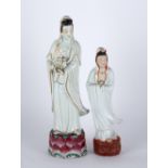 Two porcelain models of Guanyin Chinese the largest holding an object to one hand, standing on a