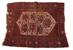 Afshar red ground rug with central ivory ground panel and geometric and foliate border, 154cm x