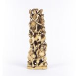 Walrus ivory okimono Japanese, early 1900 carved with a pyramid of Sumo wrestlers, signed Tamayuki ,