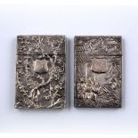 Two white metal card cases Chinese one carved in relief with figures in an outside garden, the other