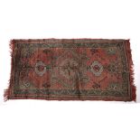 Ushak red ground rug Turkish with central medallion and foliate designs, 170cm x 92cm